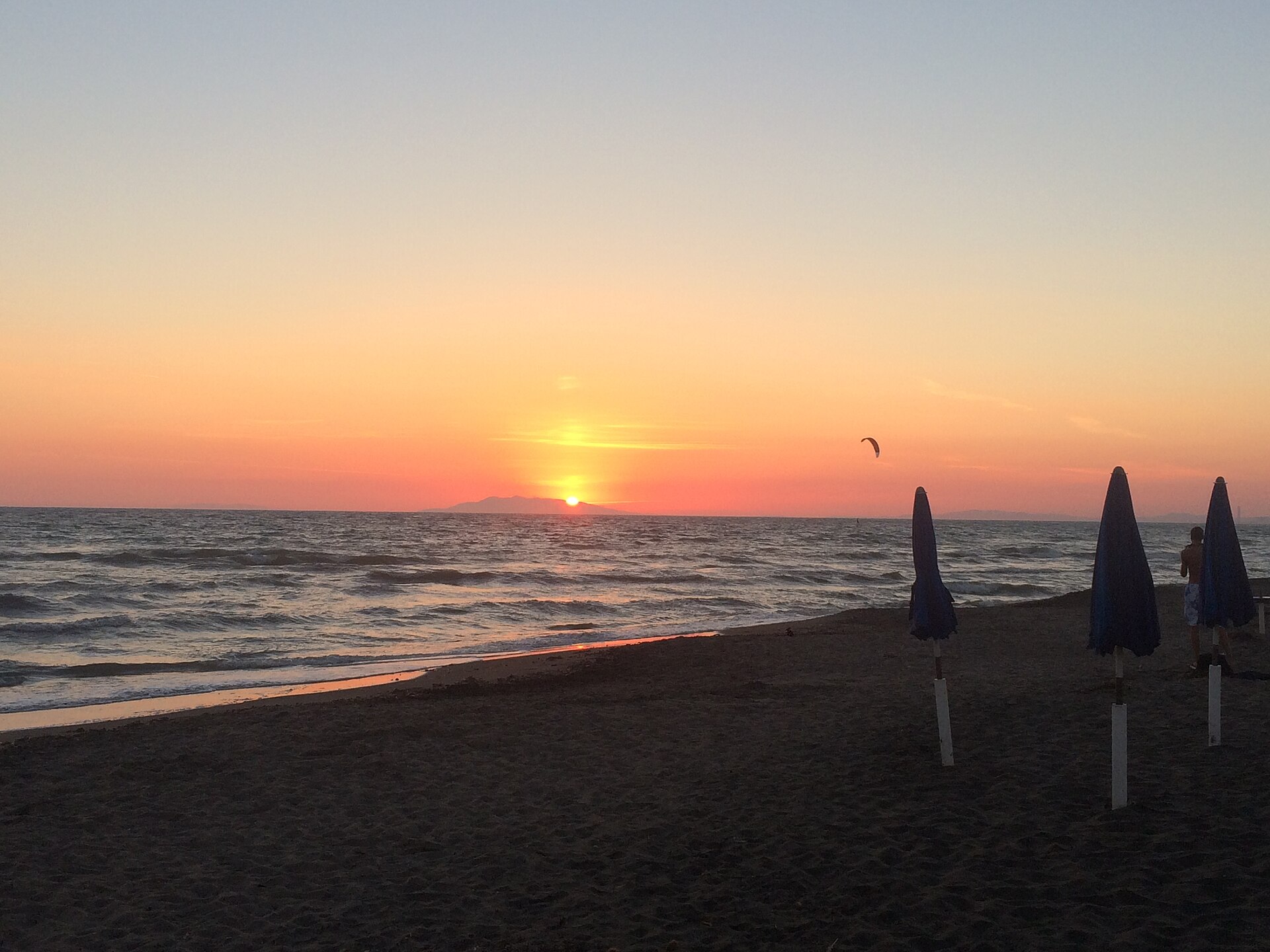 Beach umbrellas at sunset on Lido di Tarquinia
