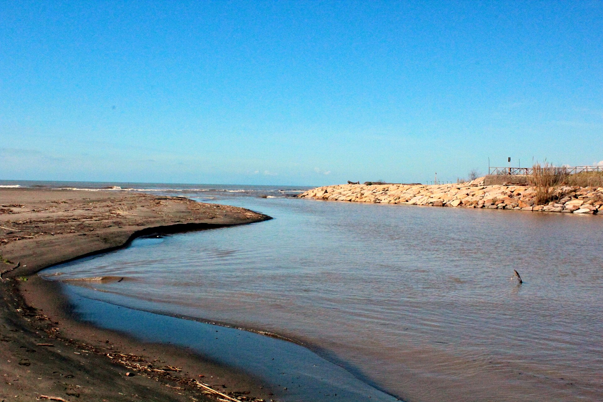 Blue sky and water at the Marta river mouth in Lido di Tarquinia